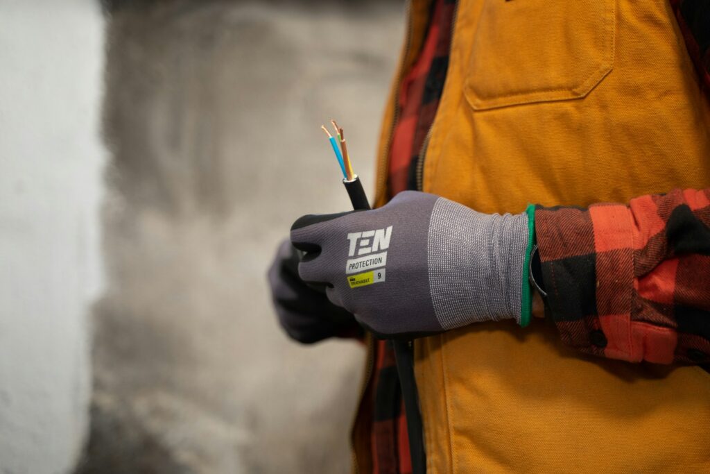 a person holding a pair of wires in their hands